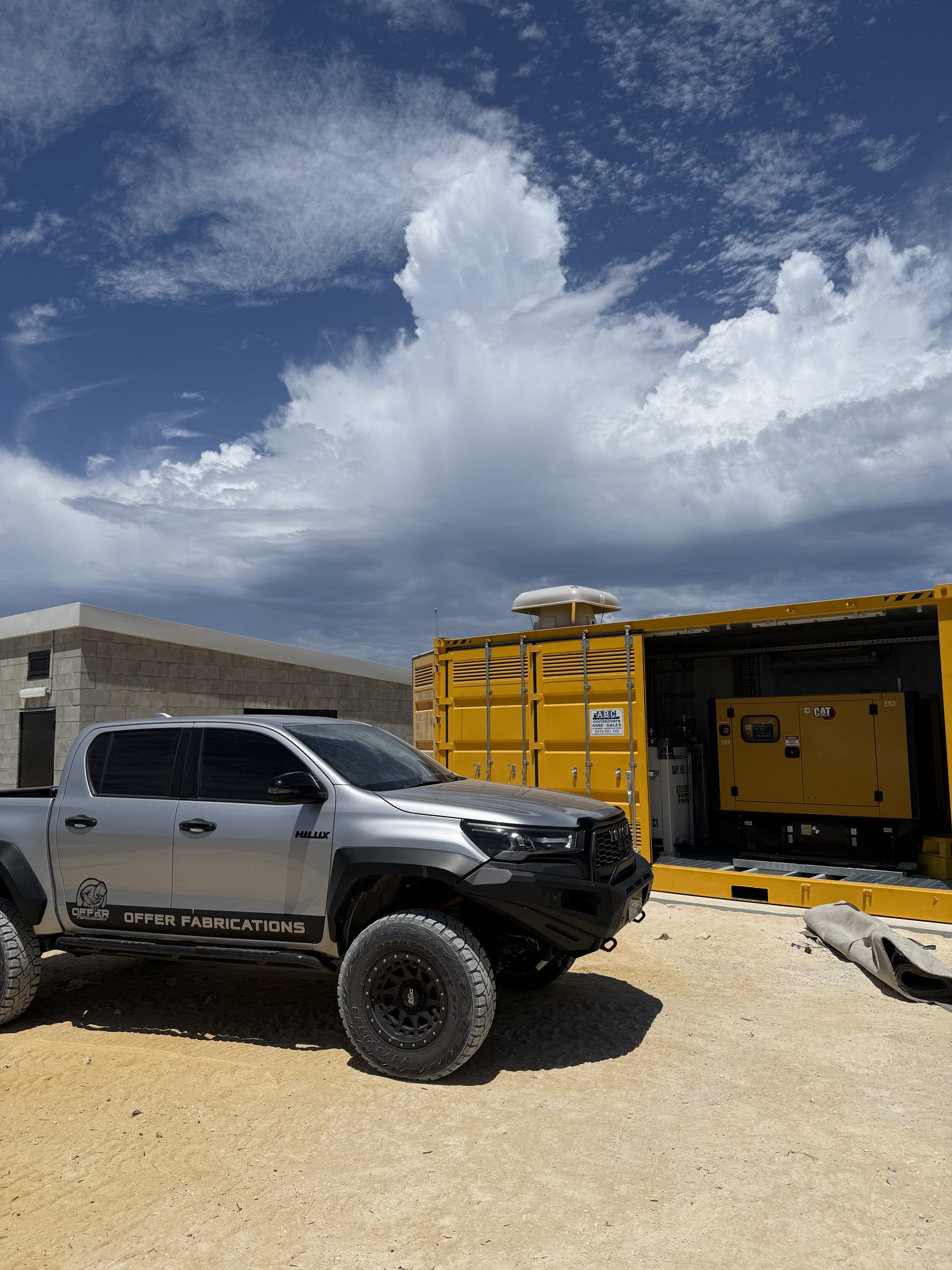 Offer Fabrications branded HiLux beside a custom-built generator enclosure